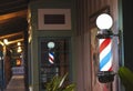 A Glowing Barber Pole on a Shop Porch