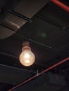 Glowing big light bulb with dark black roof Royalty Free Stock Photo