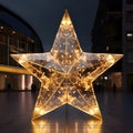 Glowing big star erected in front of a shopping mall. The Christmas star as a symbol of the birth of the savior