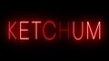 Glowing and blinking red retro neon sign for KETCHUM