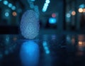 Glowing blue fingerprint on dark reflective surface. Biometric identification, cyber security concept. Digital access via