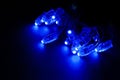 Glowing blue led pixels christmas holiday lights on black background Royalty Free Stock Photo