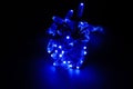 Glowing blue led pixels christmas holiday lights on black background Royalty Free Stock Photo