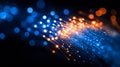 Glowing blue and orange fiber optic cable with white lights on a black background Royalty Free Stock Photo