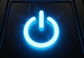 A glowing blue power button symbol is centered on a dark surface. The symbol is Royalty Free Stock Photo