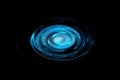 Glowing blue vortex with light effect on black backdrop, abstract background Royalty Free Stock Photo