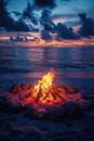 glowing bonfire on sandy beach at twilight, surrounded by rocks, with vibrant sunset reflecting on ocean Royalty Free Stock Photo