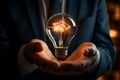 Glowing bulb in CEOs hand signifies business acumen and ingenuity