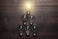 Glowing bulb leadership concept on wooden Royalty Free Stock Photo