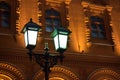 Glowing burning lantern on iron pillar on ancient building yellow brick wall background close up historical center Moscow, Russia