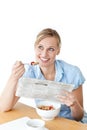 Glowing businesswoman having breakfast and reading Royalty Free Stock Photo