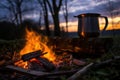 glowing campfire at dusk with kettle brewing nettle tea