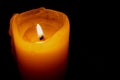 Glowing Candle Against a Black Background Royalty Free Stock Photo