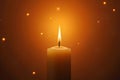 Glowing Candle Flame with Sparkle Effect on Dark Background Royalty Free Stock Photo