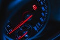 Glowing car speedometer close-up view background. Luxury dashboard with round speedometer inside sport car