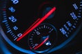 Glowing car speedometer close-up view background. Luxury dashboard with round speedometer inside sport car