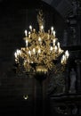 Glowing chandelier hanging in darkness