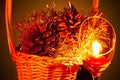 Glowing Christmas composition with goblet candle light and pine cones in a wicker basket on a dark background