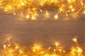 Glowing Christmas lights on wooden background, top view. Space for text Royalty Free Stock Photo