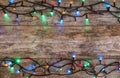 Glowing Christmas lights on wooden background Royalty Free Stock Photo