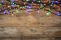 Glowing Christmas lights on wooden background, top view Royalty Free Stock Photo