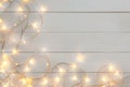 Glowing Christmas lights on wooden table Royalty Free Stock Photo