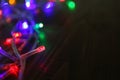 Glowing Christmas lights on wooden table, closeup Royalty Free Stock Photo