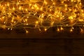 Glowing Christmas lights on wooden , top view. Space for text Royalty Free Stock Photo