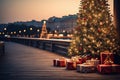 glowing Christmas tree with gift boxes on the wooden embankment. A tourist trip for Christmas and New Year to tropical countries,