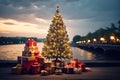 glowing Christmas tree with gift boxes on the wooden embankment. A tourist trip for Christmas and New Year to tropical countries,