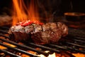 glowing coals beneath a sizzling steak on a grill