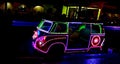 Photo of glowing LED lights in a row and in the shape of a classic car