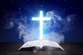 Glowing Cross With Holy Bible And Smoke Coming From The Bible