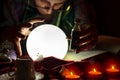 Crystal ball and love potion in hands of fortune teller woman