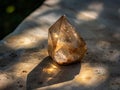 Glowing crystal quartz stone on concrete surface