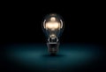 Glowing 3D light bulb on dark blue background Royalty Free Stock Photo