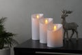 Glowing decorative LED candles on black table Royalty Free Stock Photo