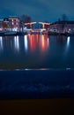 Glowing drawbridge over a canal in Amsterdam at night. City landscape Royalty Free Stock Photo