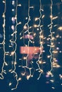 Glowing electric garlands on the night window, beautiful bright abstract celebration background and texture. Vertical shot