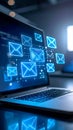 Glowing email symbols floating above a laptop keyboard displaying digital network communication technology Royalty Free Stock Photo