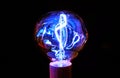 Glowing fancy tungsten filament light bulb. Royalty Free Stock Photo