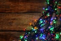 Glowing festive lights on wooden table, top view. Space for text