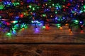 Glowing festive lights on wooden table, top view. Space for text