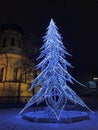 Glowing Festivities: Neon Christmas Tree Illuminates Winter Evening with Magical Charm