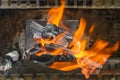 Glowing and flaming fire on barbecue coal stove