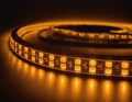 Glowing Flexible LED Strip Lights on Spools Emitting Warm Yellow Light Royalty Free Stock Photo