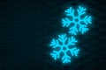 Glowing frozen snowflakes on dark wall. Neon effect. Large snowfalls in winter