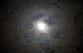 Glowing full moon surrounded by circle of moody alien clouds lit Royalty Free Stock Photo