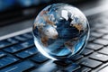 Glowing globe resting on a computer keyboard representing global connectivity and technology Royalty Free Stock Photo