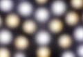 Glowing gold and silver round lights in defocused blur motion abstract background